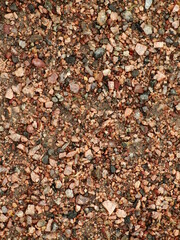Beige stone gravel background texture. Brown small rocks abstract road pavement pattern