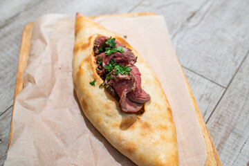 Tasty Georgian khachapuri with meat