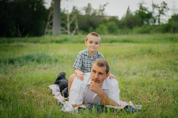 A beautiful young man with his young children in the Park.The concept of a happy family! Happy...