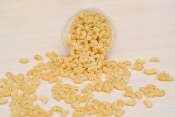 Scattered macaroni shells. Quarantine food supplies. Food stocks. Crisis. Food delivery, donations. A copy of the space. Space for text.