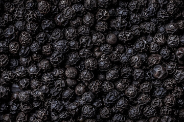 Fototapeta na wymiar Black pepper large overhead close up arrangement on dark background studio shot