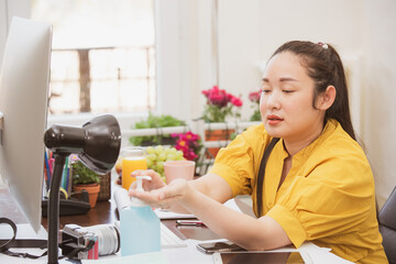 Working at home lifestyle young woman is business from the home office, happy for working in the room, using a computer, mobile phone or laptop on the desk in the room decorated with beautiful flowers