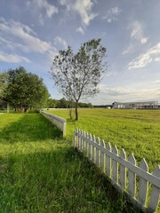 Fototapeta na wymiar rural landscape with fence and blue sky