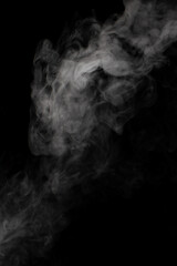 A stream of white smoke on a black background mixes randomly creating bizarre swirl patterns