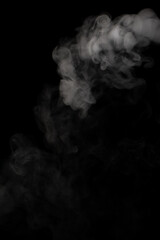 A stream of white smoke on a black background mixes randomly creating bizarre swirl patterns