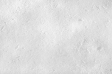 White snow on the ground on a clear sunny day. Snow texture