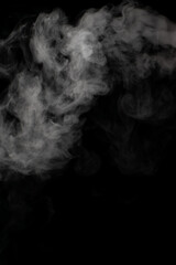 A stream of white smoke on a black background mixes randomly creating bizarre swirl patterns