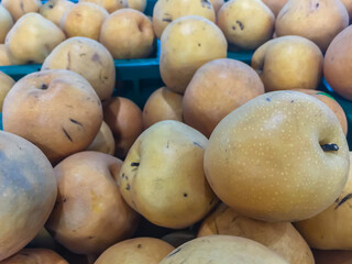 Pile of snow pear or Fengsui pear for sale in the supermarket. Pyrus nivalis, commonly known as snow pear, is a type of pear that grows naturally from south-east Europe to western Asia.