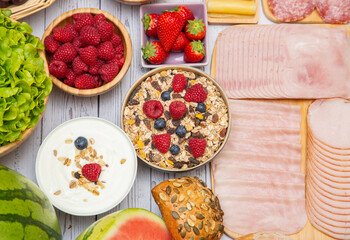 Breakfast in the morning on the table with vegetable,Croissant bread,  Bacon, ham, cheese, lettuce, beans, corn flakes and fruits for healthy breakfast Top view with copy space