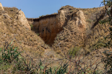 Mountain landslide in an environmentally hazardous area. Large cracks in earth, descent of large...