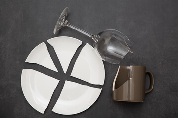 Broken Plate or broken water glass and dishes on black background concept of accidents in the...