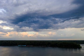 Obraz premium panoramic view of the river with floating boats and beautiful clouds shot from a drone