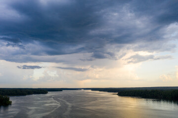 Fototapeta premium panoramic view of the river with floating boats and beautiful clouds shot from a drone