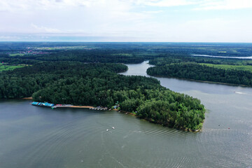 Fototapeta premium panoramic view of the river with floating boats and beautiful clouds shot from a drone