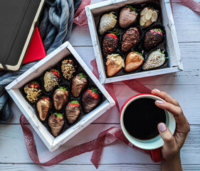 gift set of strawberries with real Belgian chocolate with added nuts and natural dyes on a wooden background with an atmosphere for a delicious Breakfast