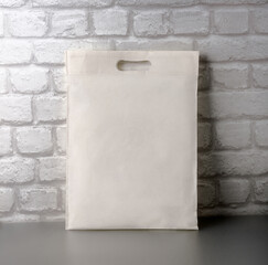 An empty, clean cloth bag against a brick wall. Layout for your ad. Stylized stock photos. Banner.