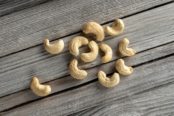 Cashew nuts scattered on a wooden background, rustic, Scandinavian style.