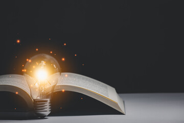 Book and light bulb style vintage dark background,.Concept The idea of reading books, knowledge, and searching for new ideas.