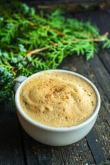 cup of coffee and twigs spruce on the table, new year mood Menu concept serving size. food background top view copy space for text