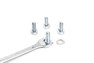 Spanners and screw nuts isolated on white background. Selective focus.