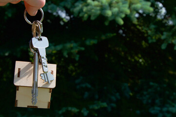 Keys and toy house on green background. Rent house concept. New house concept. Sale house concept. Real estate concept. Housing