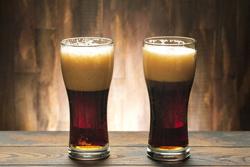 Two glass with dark beer and foam