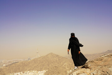 Natural full body young muslim woman portrait in Ghar Thowr, Mecca, Saudi Arabia, in a sunny and clear sky day
