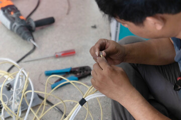 The electrician is connecting the phone to the system,blur