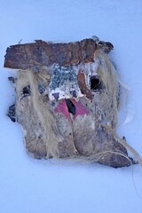 Christmas mask made of bark and wool in the snow