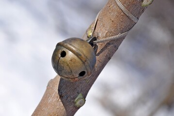 metal bell on a wooden stick
