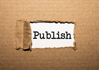 The text publish. behind torn brown paper