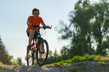 young cyclist, drove to the top of the hill, bottom view