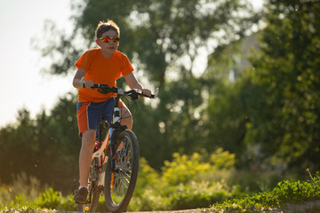 Cycling, boy cyclist in sunglasses, close up. Copyspace