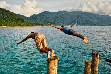 man jumping in water in Tioman island, Malaysia