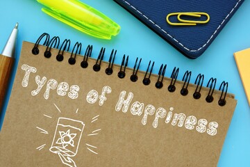 Types of Happiness inscription on the piece of paper.