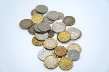 Pile of assorted international coins in gold and silver