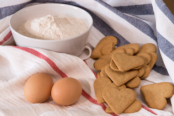 Gourmet close up with a bowl full of flour, cookies and two eggs