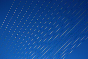 Silver wires across a blue sky