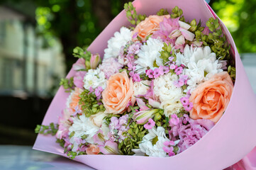Beautiful pastel bouquet of fresh fragrant flowers made by a florist. Cute birthday or holiday present.