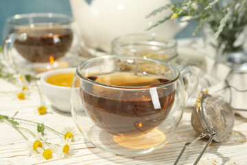 Composition with chamomile tea on white wooden table