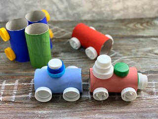 Train with railway, children's creative, from recycling, rolls of paper and plastic lids.