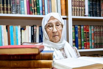 Arabic muslim woman supervising library and asking people to keep quiet