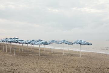 Beach with umbrellas. Morning on the sea. Empty beach