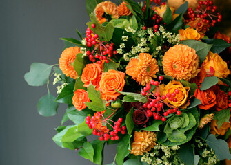 Beautiful bouquet of bright orange flowers with different garden bright plants