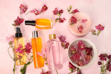 Spa and wellness composition with fragrant water from pink flowers of the wild archidea, aromatherapy with rose water and body cream and skin and body care, flat lay-out, lifestyle concept, invitation