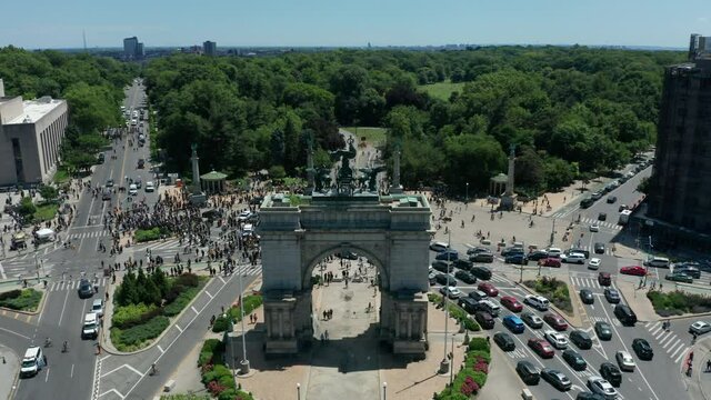flying over arch towards revealing huge BLM protest at Grand Army Plaza in Brooklyn
