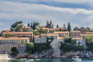Fototapeta na wymiar Famous Sveti Stefan (now Aman Sveti Stefan) - small islet and Luxury hotel resort in Montenegro, approximately 6 kilometers southeast of Budva. Montenegro, Europe.