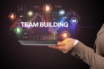 Close-up of a touchscreen with TEAM BUILDING inscription, business opportunity concept