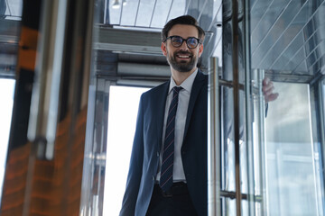 Young businessman coming in the hotel in a good mood