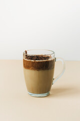 A cup of Dalgona coffee drink on yellow table